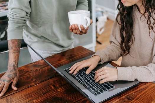 freelancer working on a laptop with a coffee