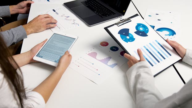 person analyzing stock market data on a laptop