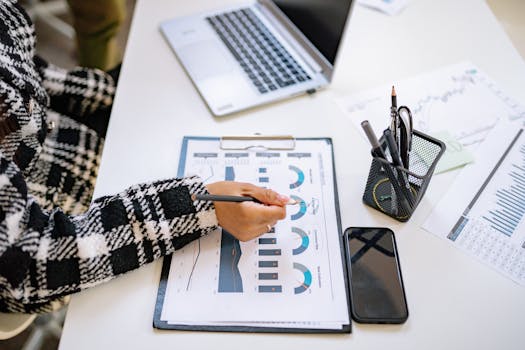 person writing financial goals on a notepad