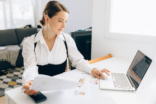 a young professional confidently reviewing financial documents